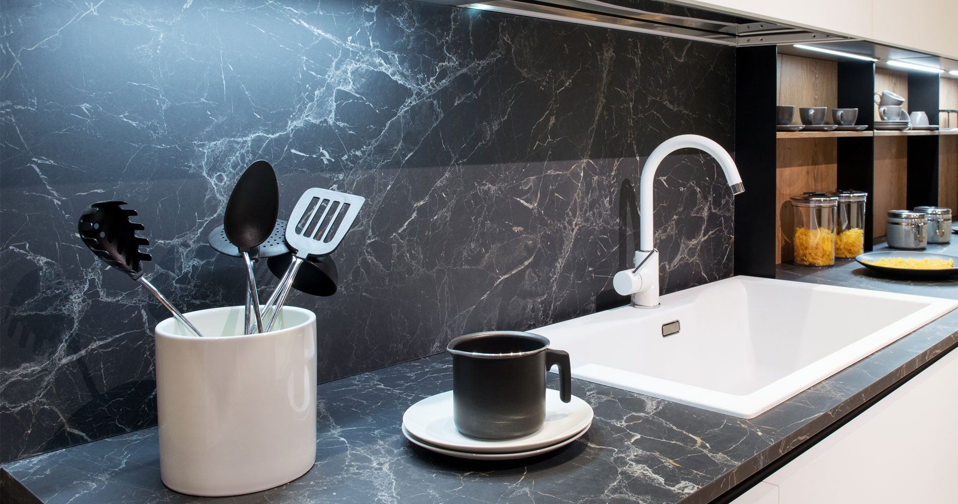 Beautiful custom stone and glass splashbacks with white sink